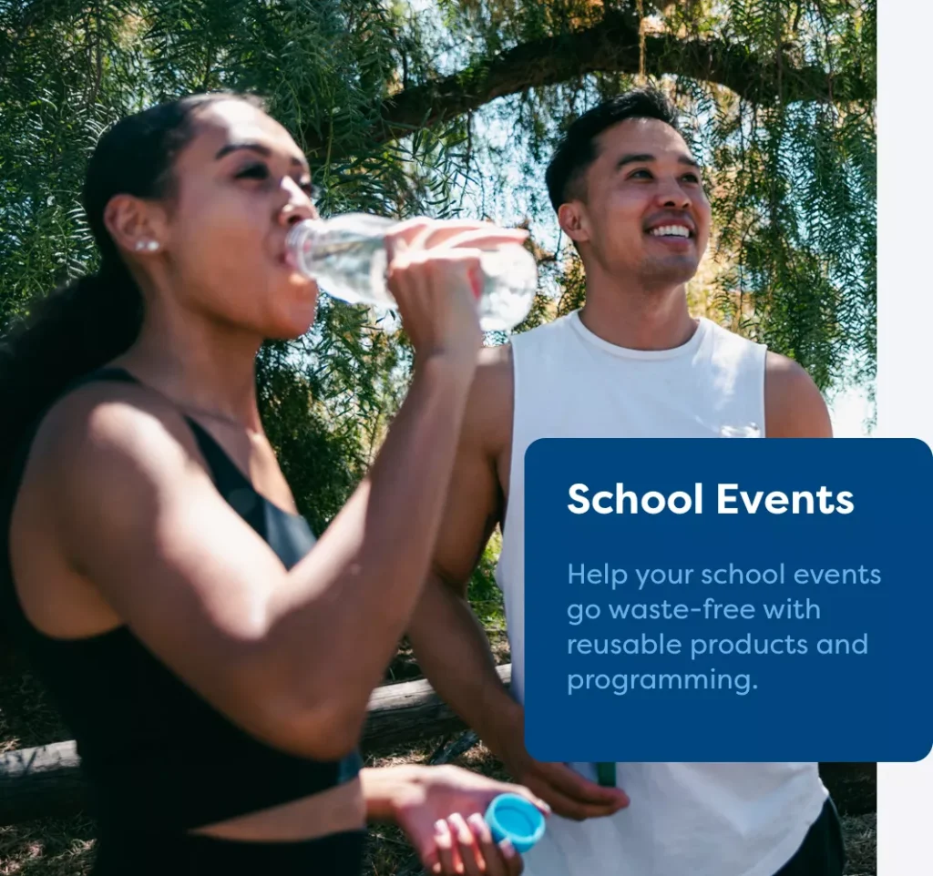 A woman and a man standing outside while the woman drinks out of her Fill it Forward reusable bottle.